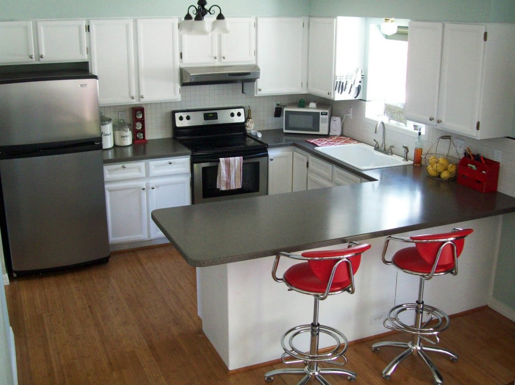 A neat and clean kitchen with two chairs
